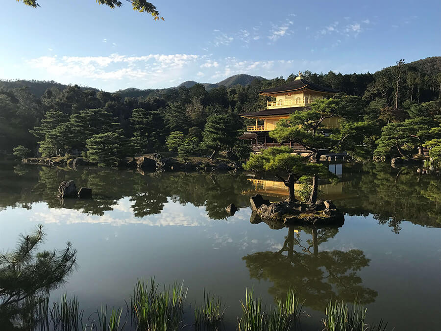 Japanese building in forested area near water